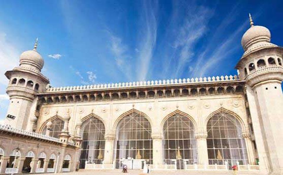 A grand old mosque with arches and minarets